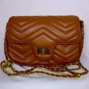 Brown colored waffle style handbag.
